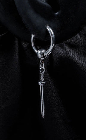 silver-colored hoop earrings with dangling sword charms.