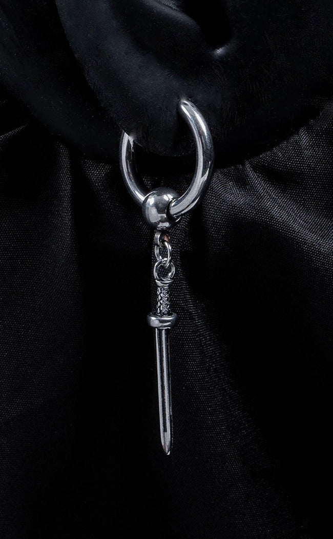 silver-colored hoop earrings with dangling sword charms.